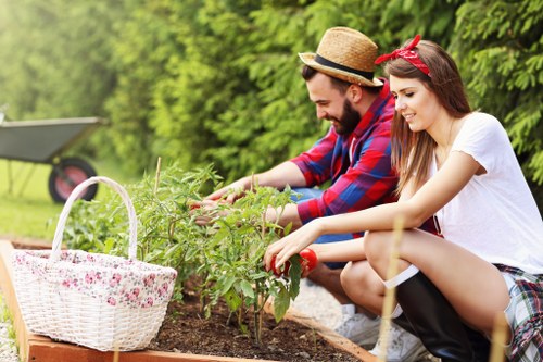 A gardening team following safe working standards on site